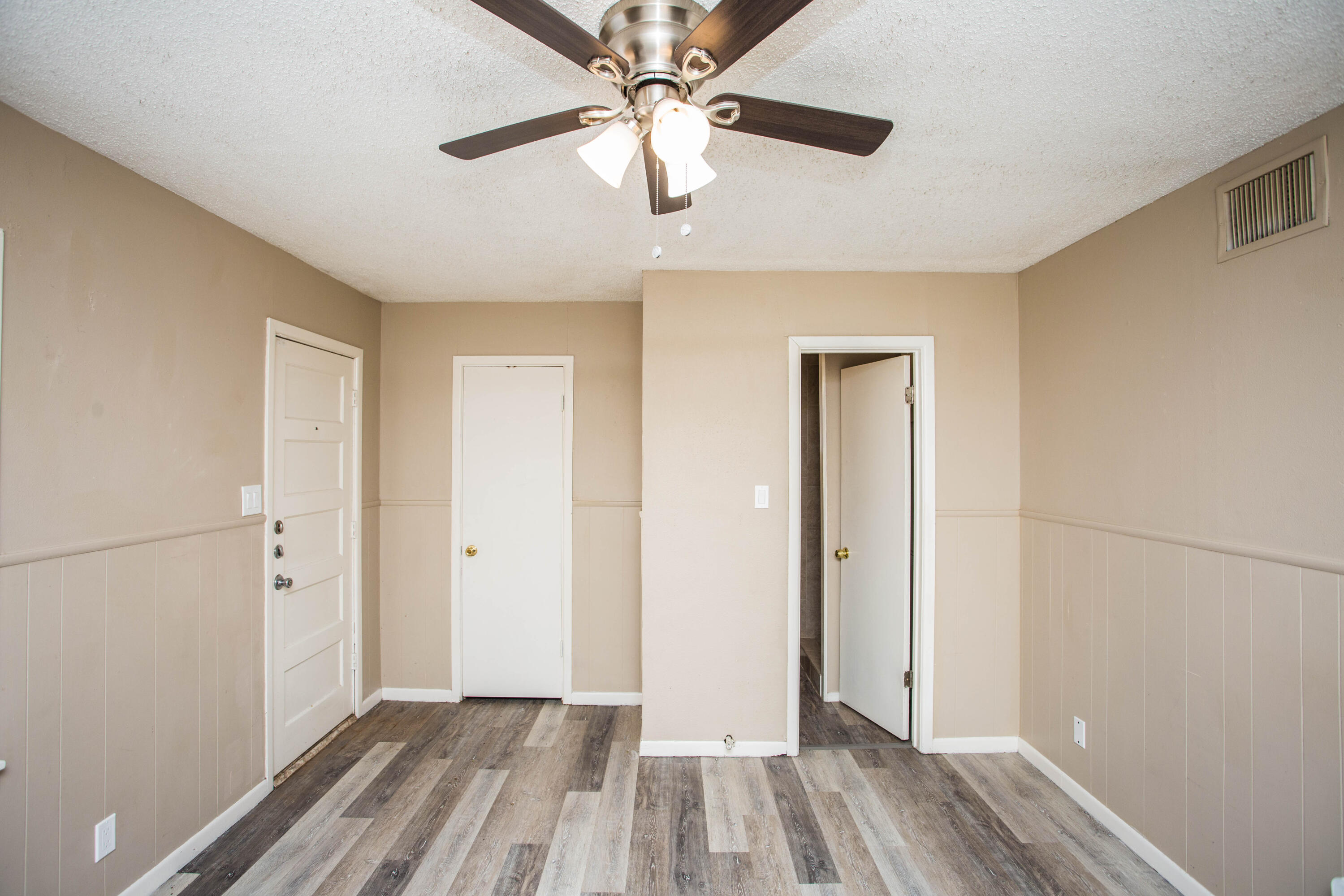 4309 42nd Street Lubbock, TX 79413 - Photo 11 of 25 wooden floor in an empty room with a window