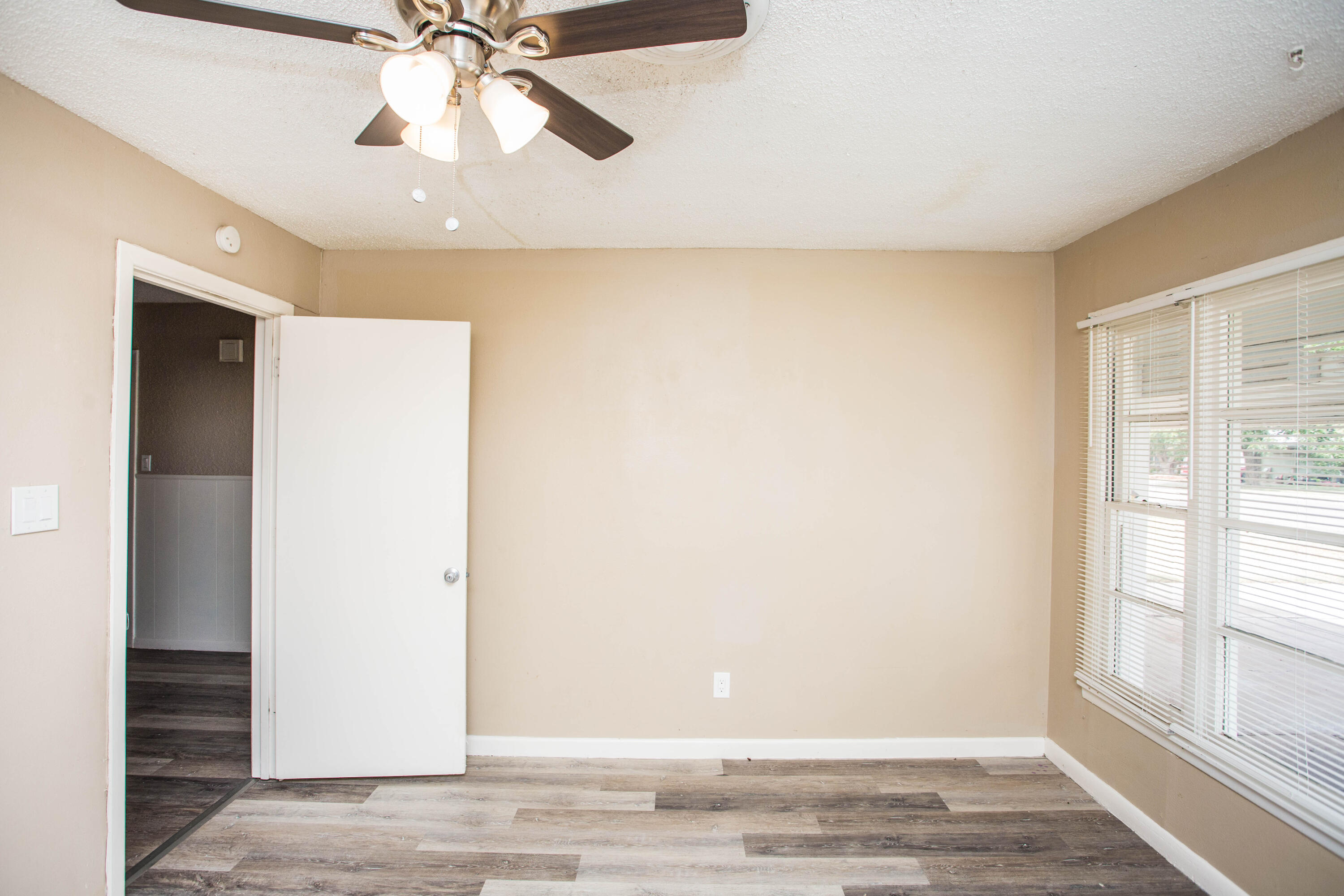 4309 42nd Street Lubbock, TX 79413 - Photo 15 of 25 a view of a livingroom with a ceiling fan and window