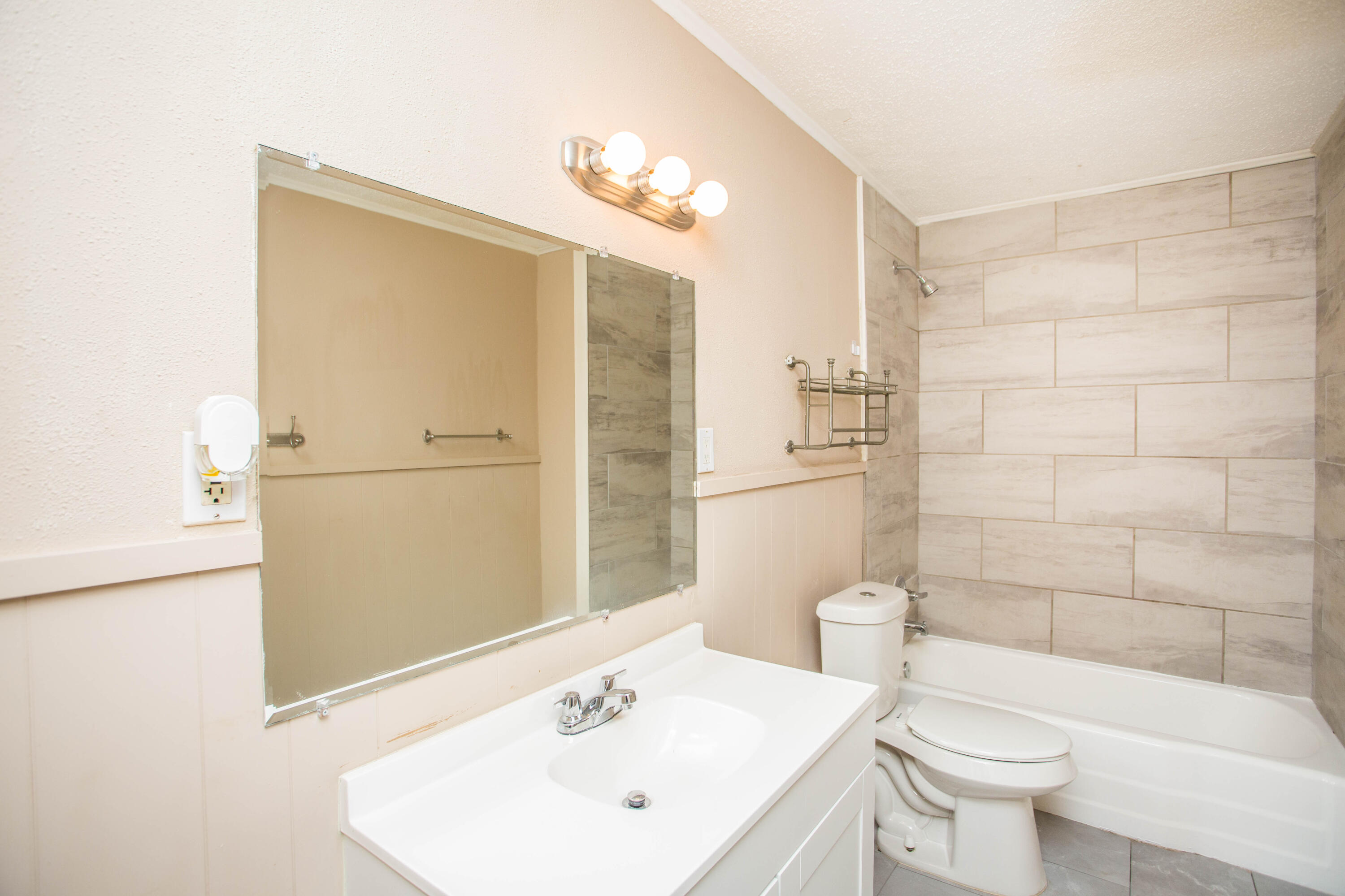 4309 42nd Street Lubbock, TX 79413 - Photo 16 of 25 a bathroom with a sink a toilet and shower