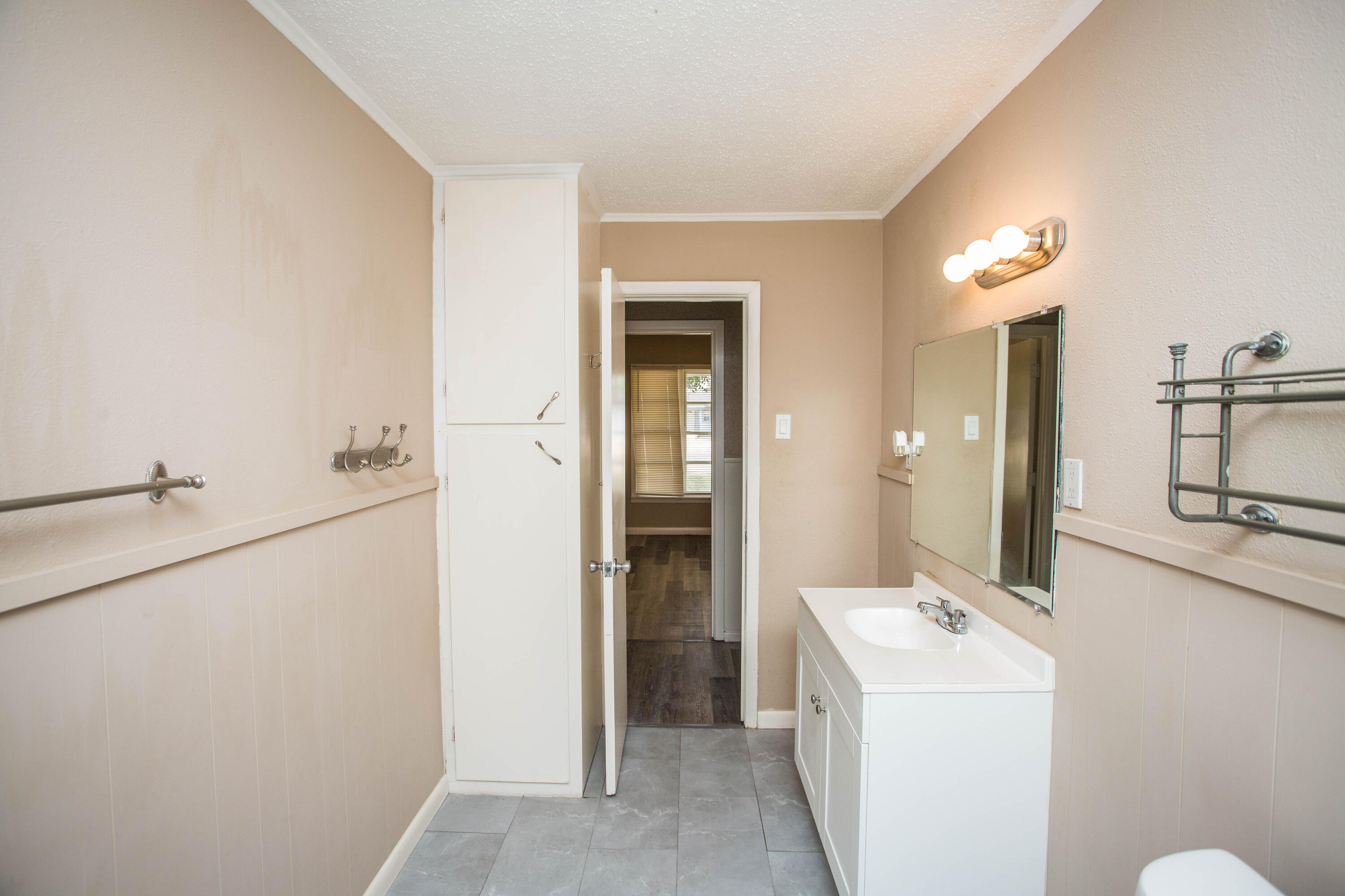 4309 42nd Street Lubbock, TX 79413 - Photo 17 of 25 a bathroom with a sink and mirror