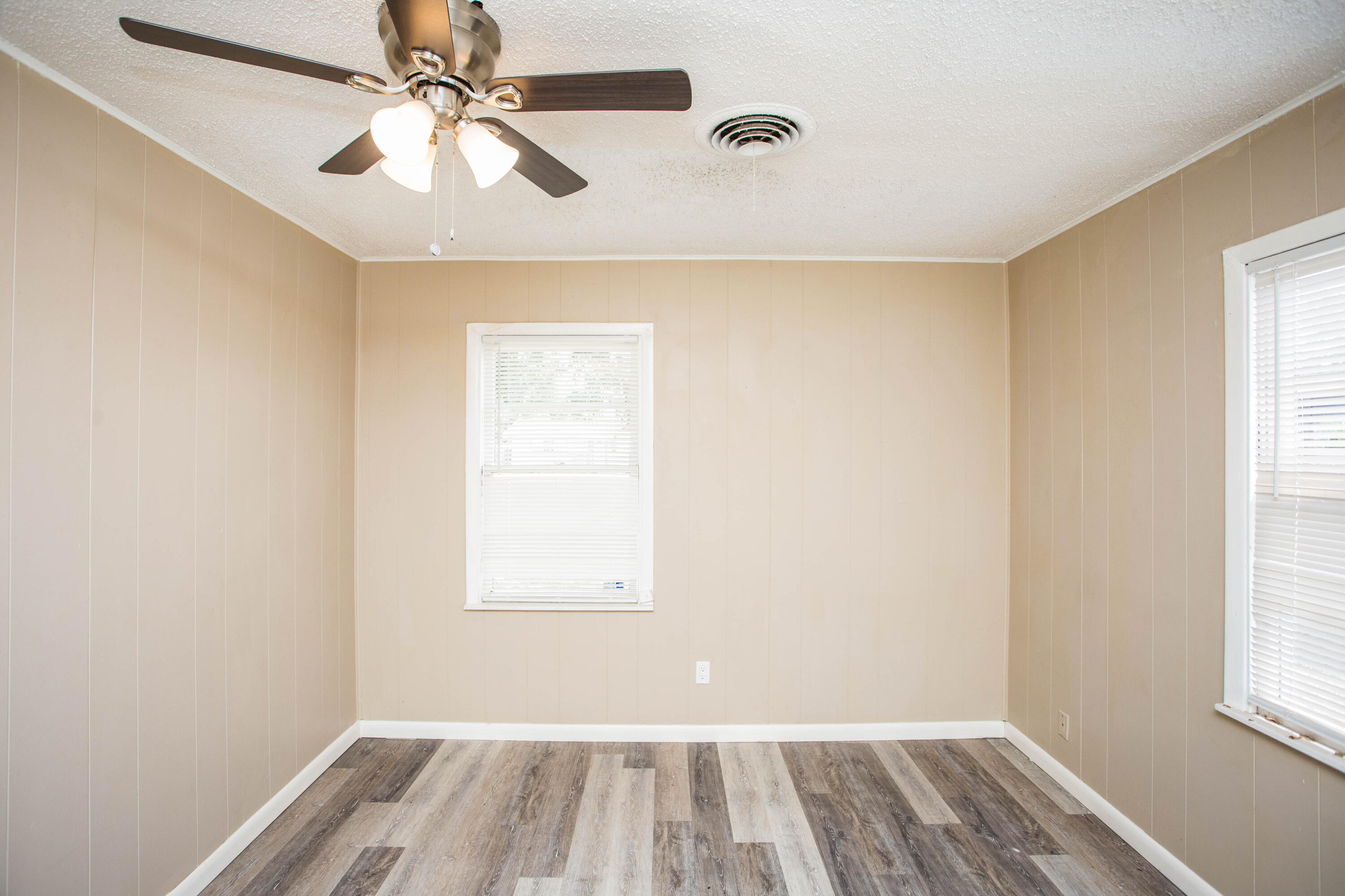 4309 42nd Street Lubbock, TX 79413 - Photo 18 of 25 an empty room with windows and fan