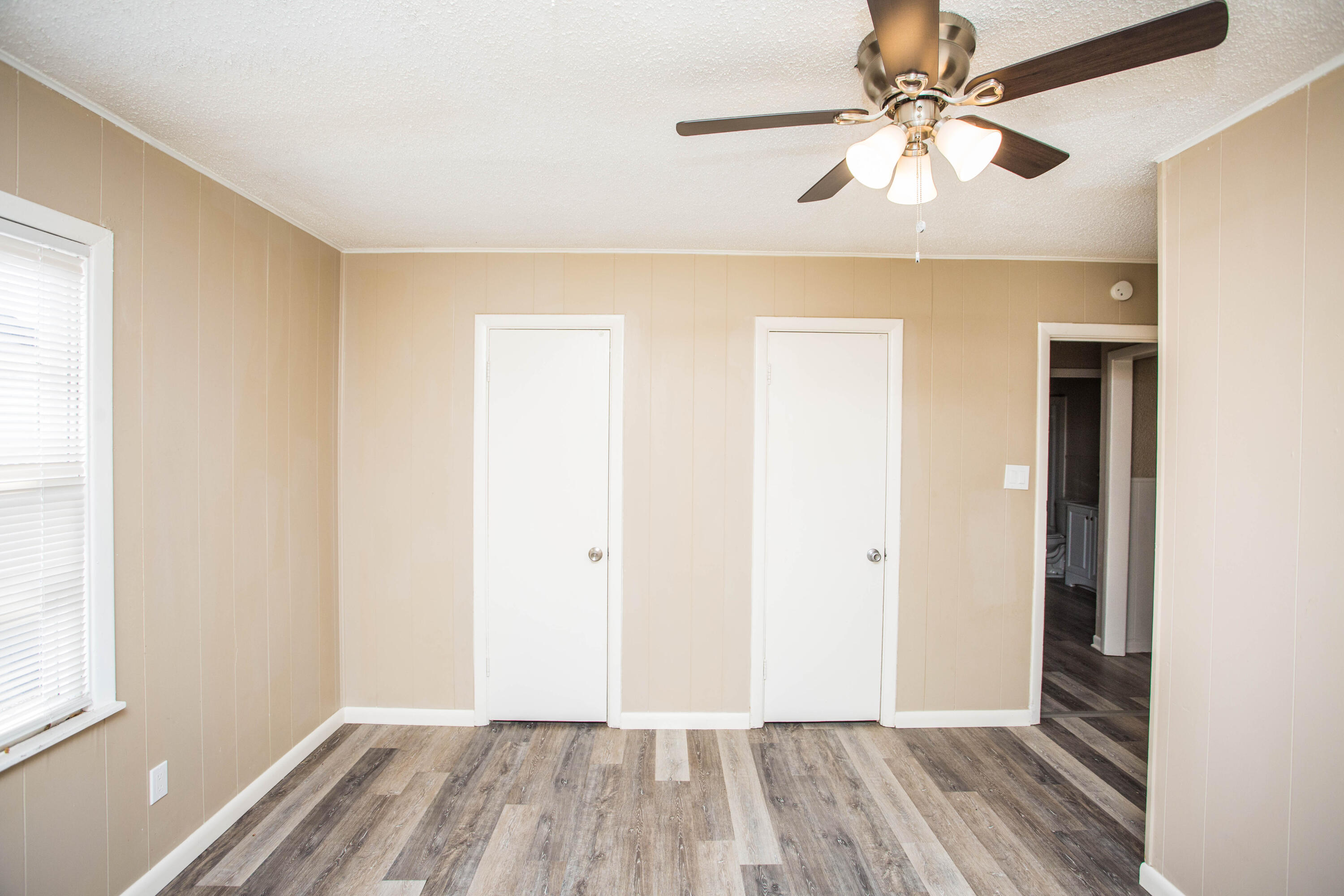 4309 42nd Street Lubbock, TX 79413 - Photo 19 of 25 wooden floor in an empty room with a window