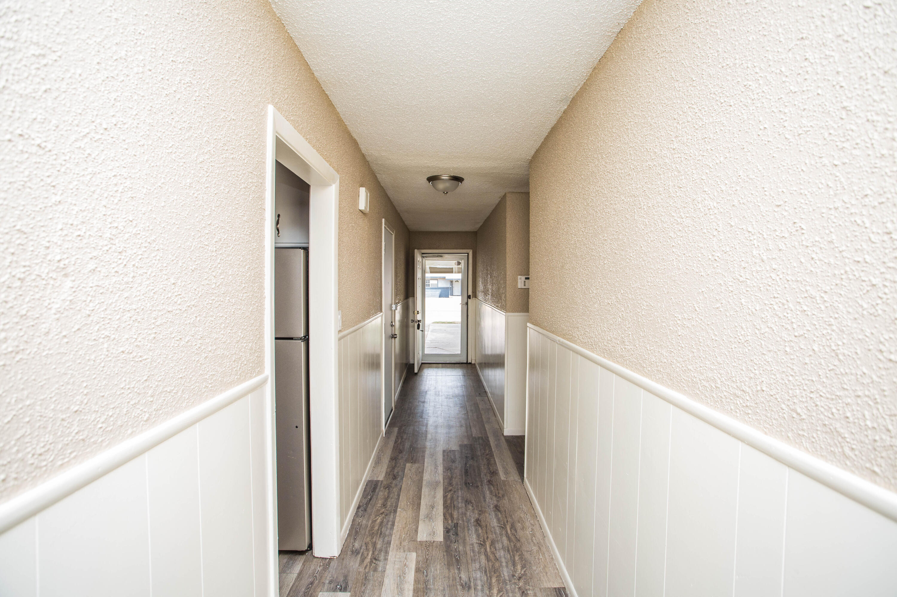 4309 42nd Street Lubbock, TX 79413 - Photo 2 of 25 a view of a hallway with wooden floor and staircase