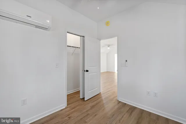 a view of an empty room with wooden floor