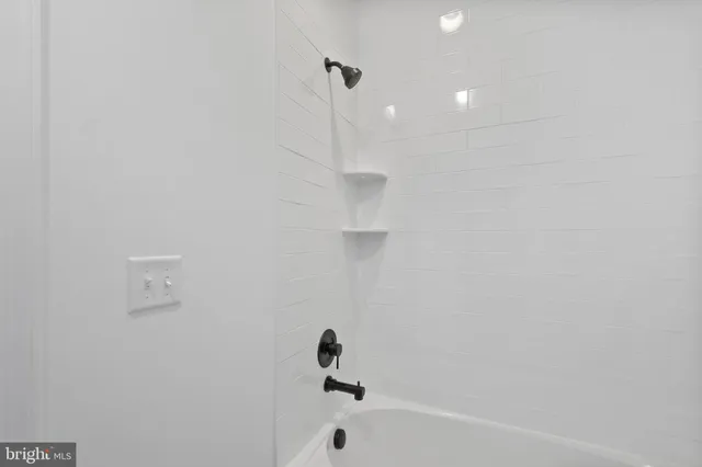 a bathroom with a bathtub and a shower