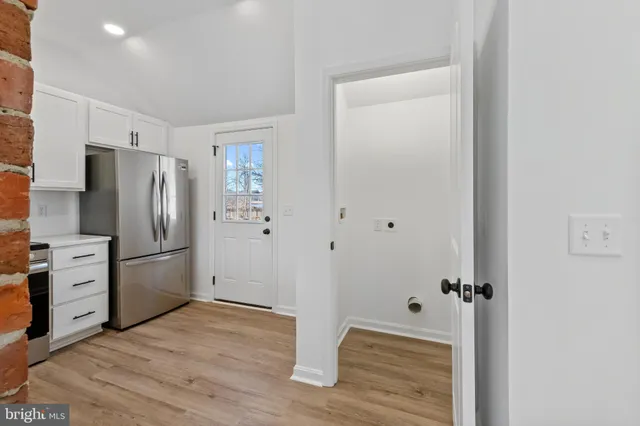 a kitchen with a refrigerator cabinet and a stove