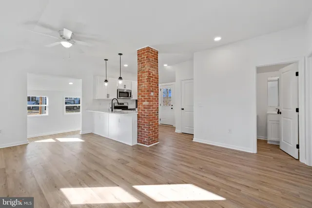 a view of a kitchen with wooden floor and a kitchen