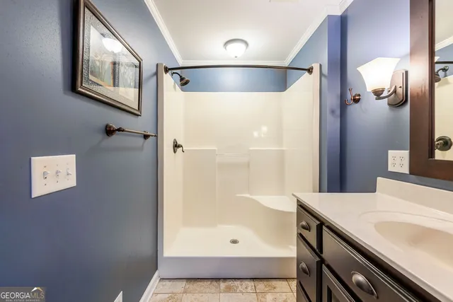 a white toilet sitting next to a white wall