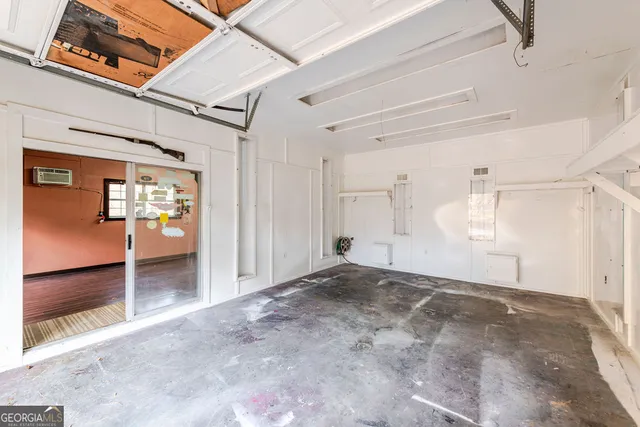 a view of a hallway with wooden floor and furniture