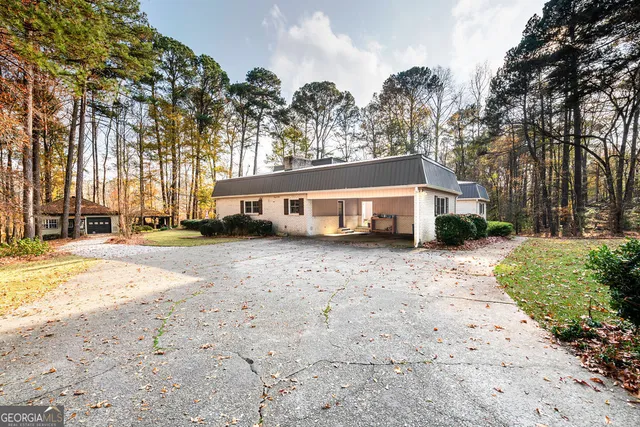 a backyard of a house with yard and outdoor seating