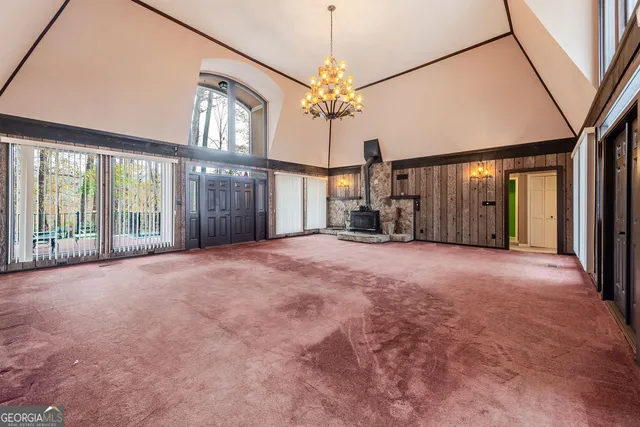 a view of a livingroom with furniture staircase and a ceiling fan
