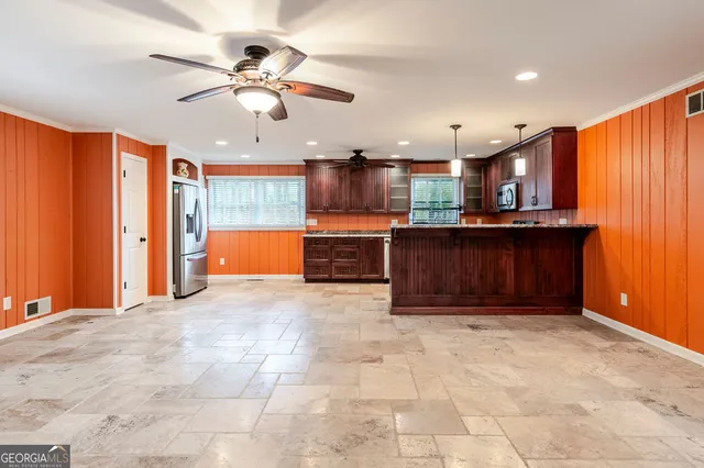 a view of kitchen with cabinets and chandelier