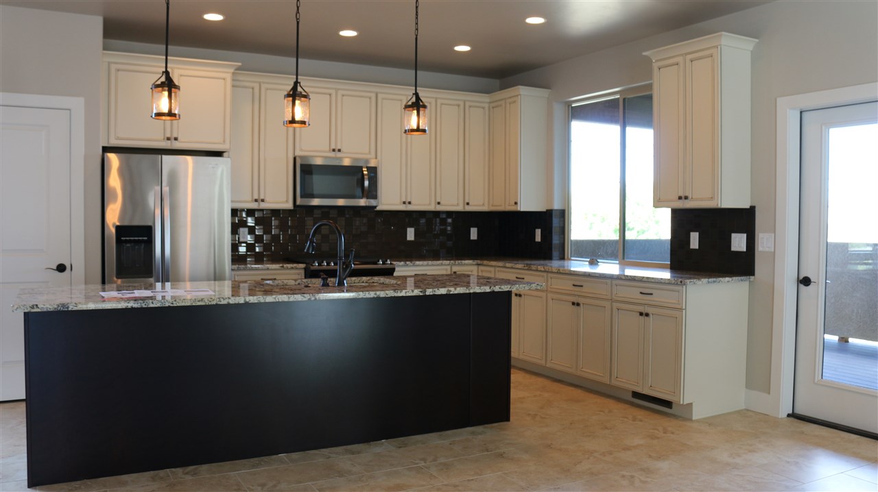 498 Tiara Rado Court Grand Junction, CO 81507 - Photo 16 of 20 a kitchen with stainless steel appliances granite countertop a sink a stove and a refrigerator