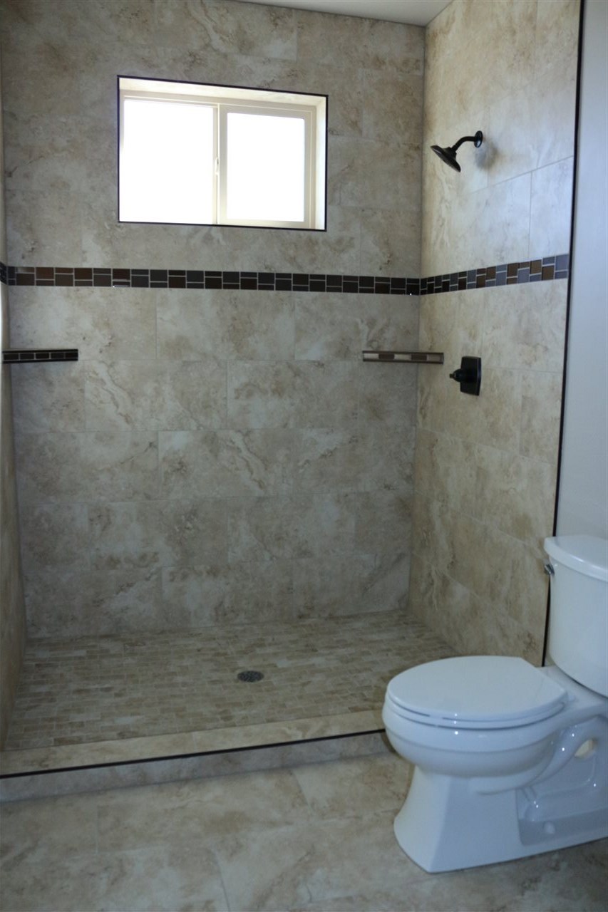 498 Tiara Rado Court Grand Junction, CO 81507 - Photo 20 of 20 a white toilet sitting next to a shower