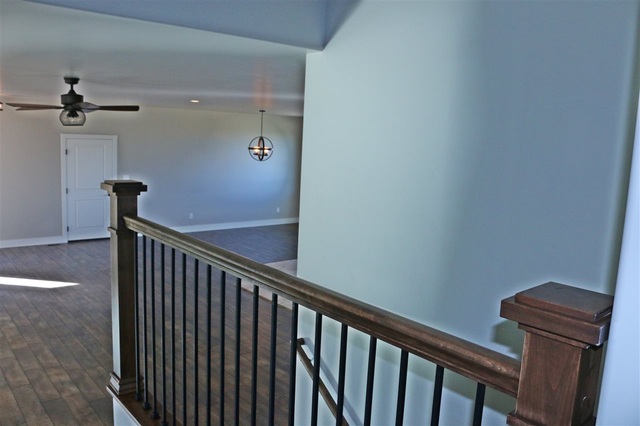 498 Tiara Rado Court Grand Junction, CO 81507 - Photo 9 of 20 a view of a hallway with wooden floor