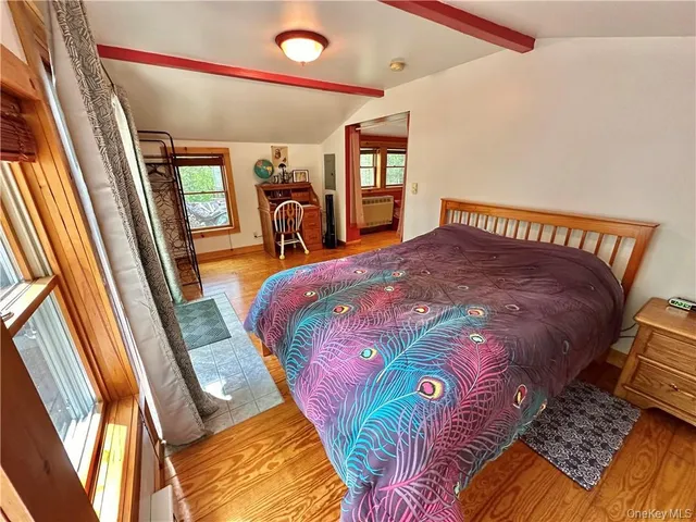 a bed sitting in a bedroom next to a window