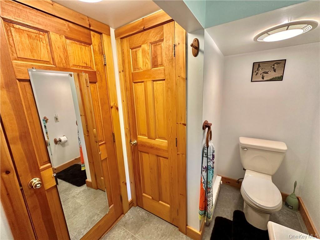 29 Dymond Road Kerhonkson, NY 12446 - Photo 18 of 18 a bathroom with a granite countertop shower a toilet and a sink