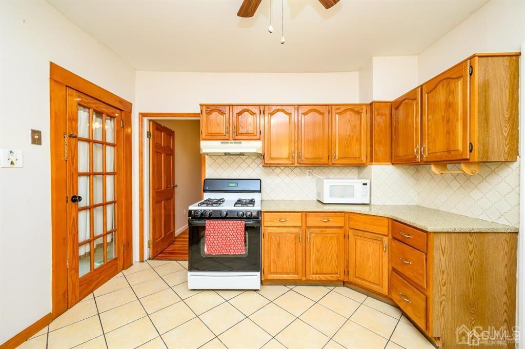 47 Marion Street Port Reading, NJ 07064 - Photo 16 of 57 a kitchen with stainless steel appliances a refrigerator and sink