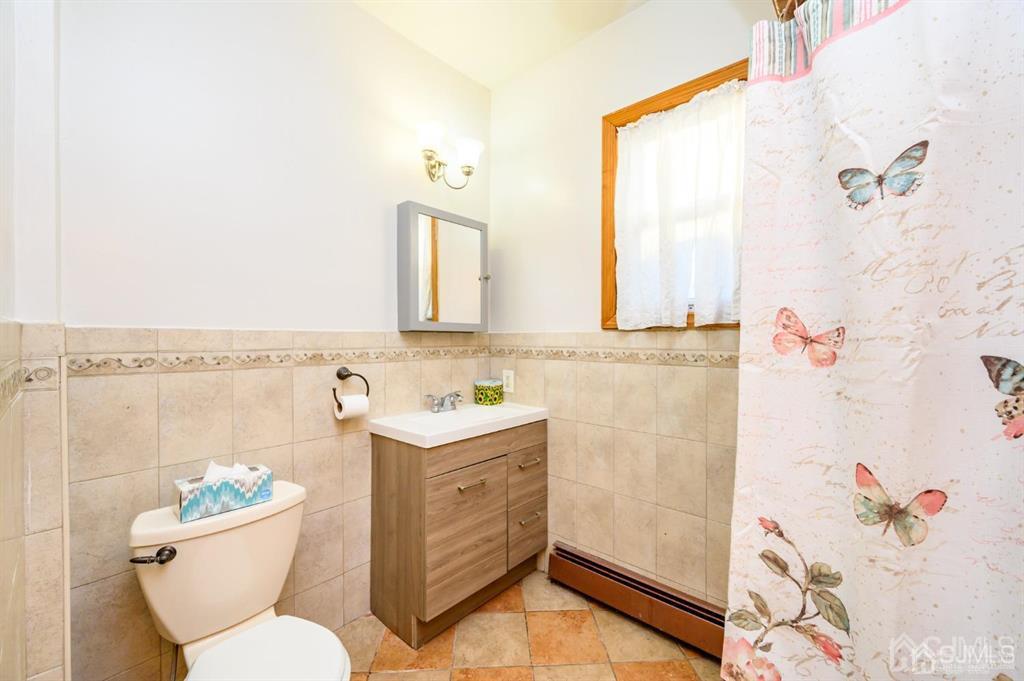 47 Marion Street Port Reading, NJ 07064 - Photo 19 of 57 a bathroom with a sink mirror vanity and toilet