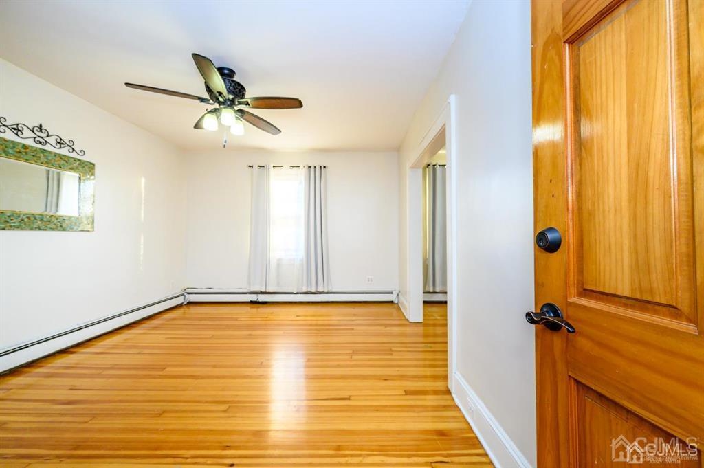 47 Marion Street Port Reading, NJ 07064 - Photo 24 of 57 a view of a room with a window and wooden floor