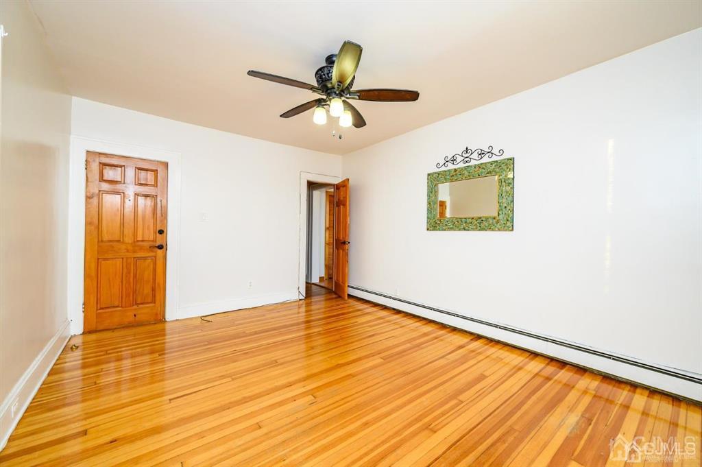 47 Marion Street Port Reading, NJ 07064 - Photo 25 of 57 a view of empty room with wooden floor