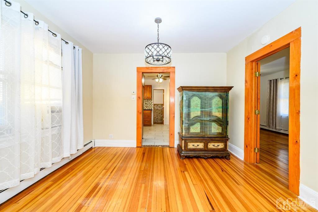 47 Marion Street Port Reading, NJ 07064 - Photo 30 of 57 a view of a room with wooden floor wooden floor and windows
