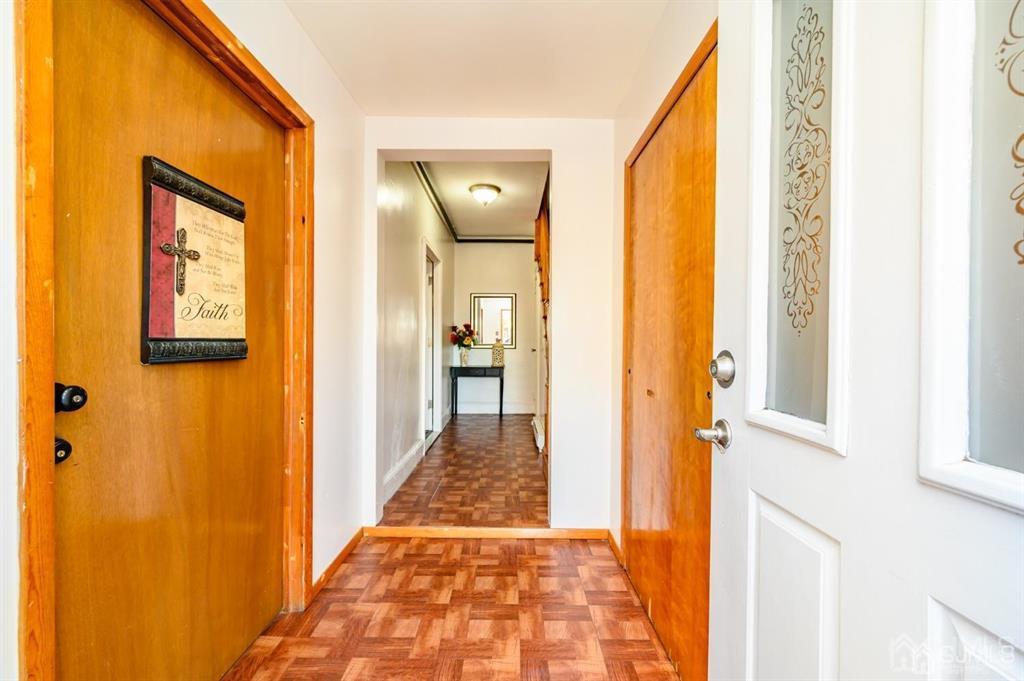 47 Marion Street Port Reading, NJ 07064 - Photo 3 of 57 a view of a hallway with wooden floor and a bathroom
