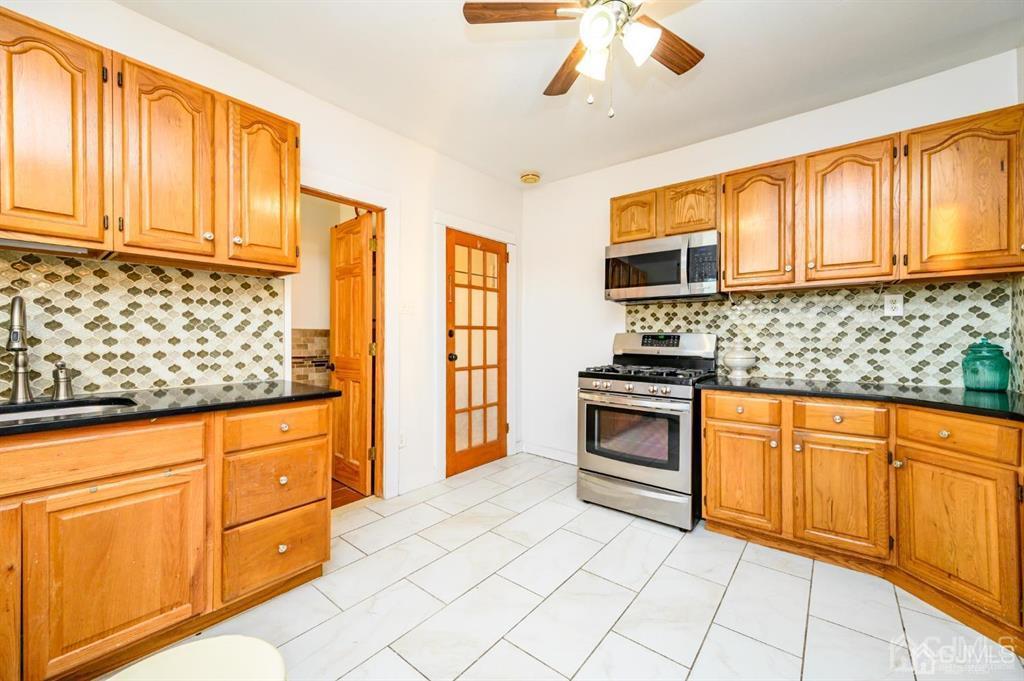 47 Marion Street Port Reading, NJ 07064 - Photo 35 of 57 a kitchen with stainless steel appliances granite countertop a stove sink and cabinets