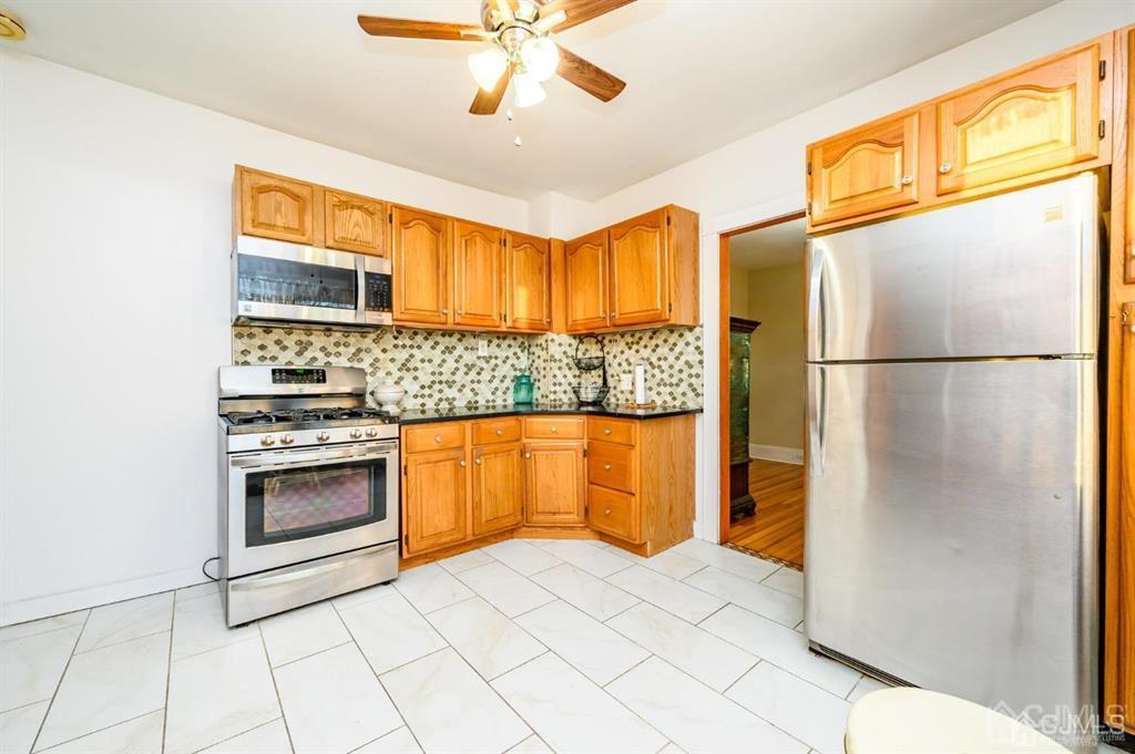 47 Marion Street Port Reading, NJ 07064 - Photo 36 of 57 a kitchen with stainless steel appliances granite countertop a refrigerator a oven and a sink with granite countertops
