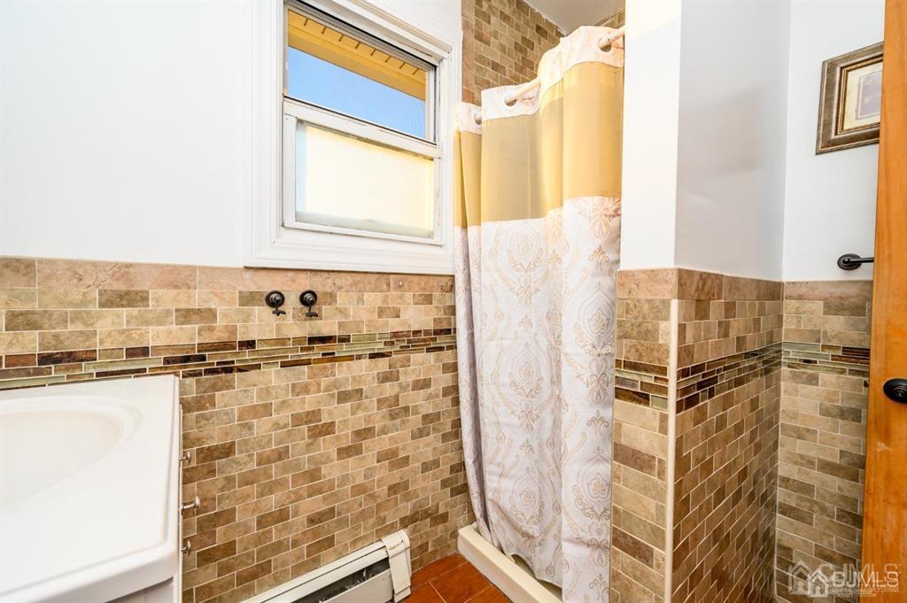 47 Marion Street Port Reading, NJ 07064 - Photo 40 of 57 a view of a bathroom with a shower