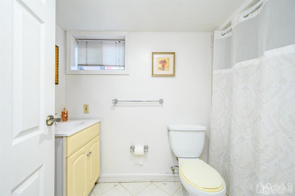47 Marion Street Port Reading, NJ 07064 - Photo 50 of 57 a bathroom with a sink a toilet and a shower