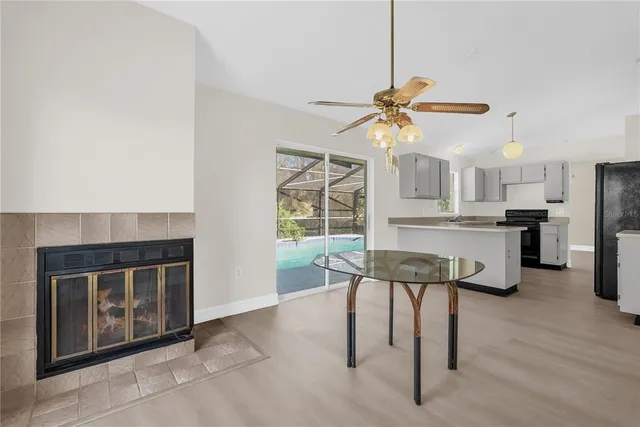 a living room with stainless steel appliances kitchen island granite countertop furniture and a fireplace
