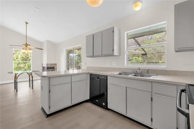 a kitchen with sink cabinets and window