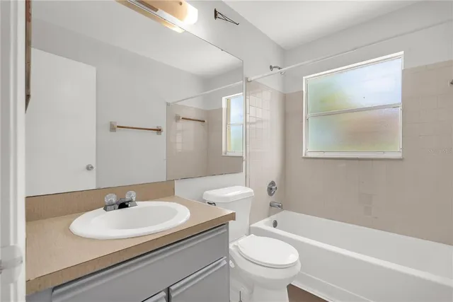 a bathroom with a sink toilet a mirror and shower