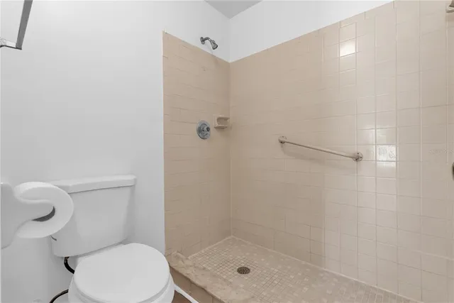 a bathroom with a shower a toilet and a sink