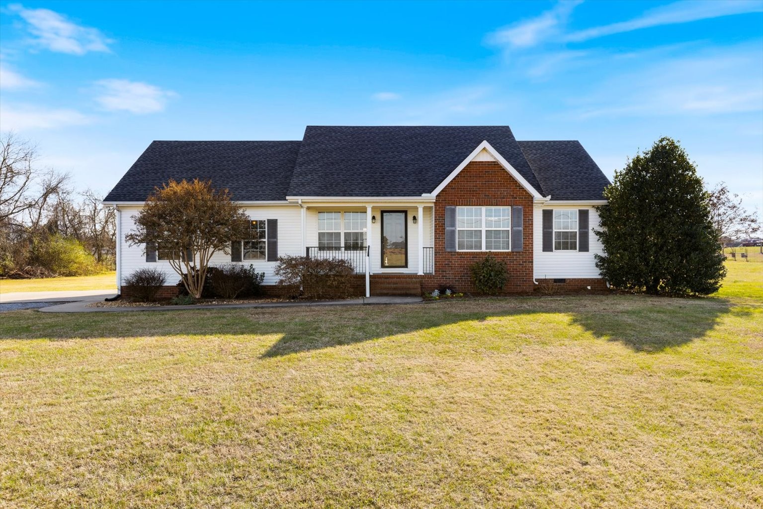 4923 Midland Fosterville Road Bell Buckle, TN 37020 - Photo 1 of 35 a front view of a house with a yard