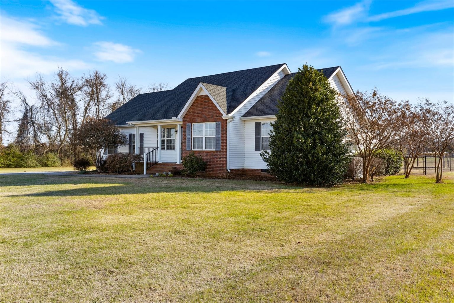 4923 Midland Fosterville Road Bell Buckle, TN 37020 - Photo 4 of 35 a front view of a house with a yard