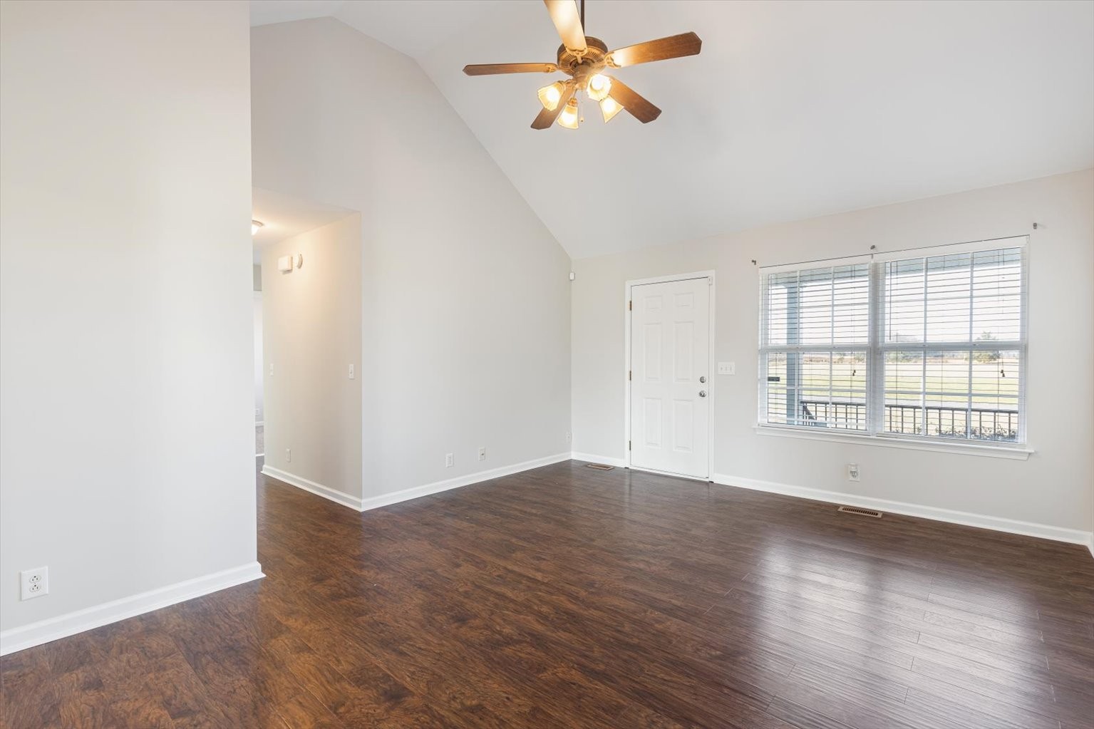 4923 Midland Fosterville Road Bell Buckle, TN 37020 - Photo 8 of 35 an empty room with wooden floor fan and windows