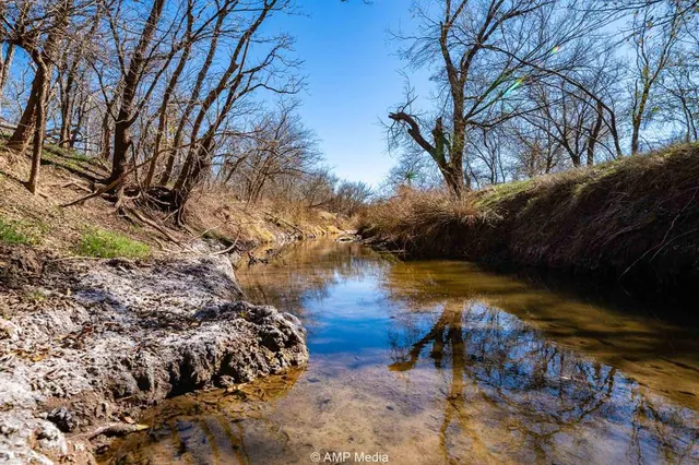 a backyard of a house with a yard and outdoor seating