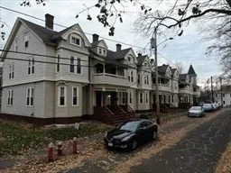 a front view of a house with parking space