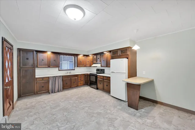 a kitchen with a refrigerator and a sink