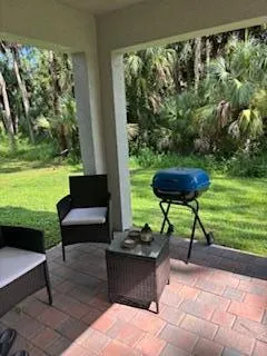 a view of a chair and table in the garden