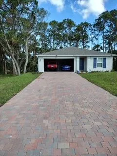 a front view of a house with a yard and a garage