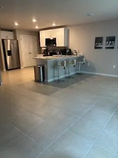 a large kitchen with a large counter top appliances and cabinets
