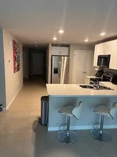 a room with pool table and chairs