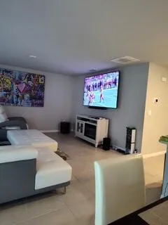 a living room with furniture and a flat screen tv