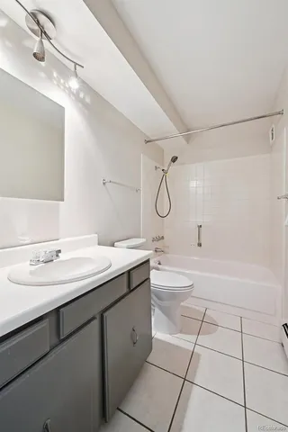 a spacious bathroom with a double vanity sink mirror and bathtub