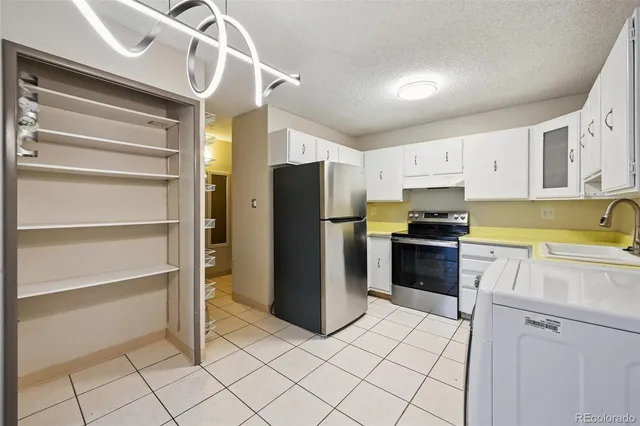 a kitchen with a refrigerator and cabinets