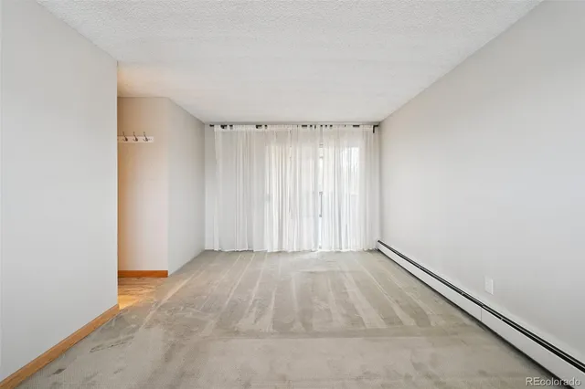 an empty room with a empty space and windows