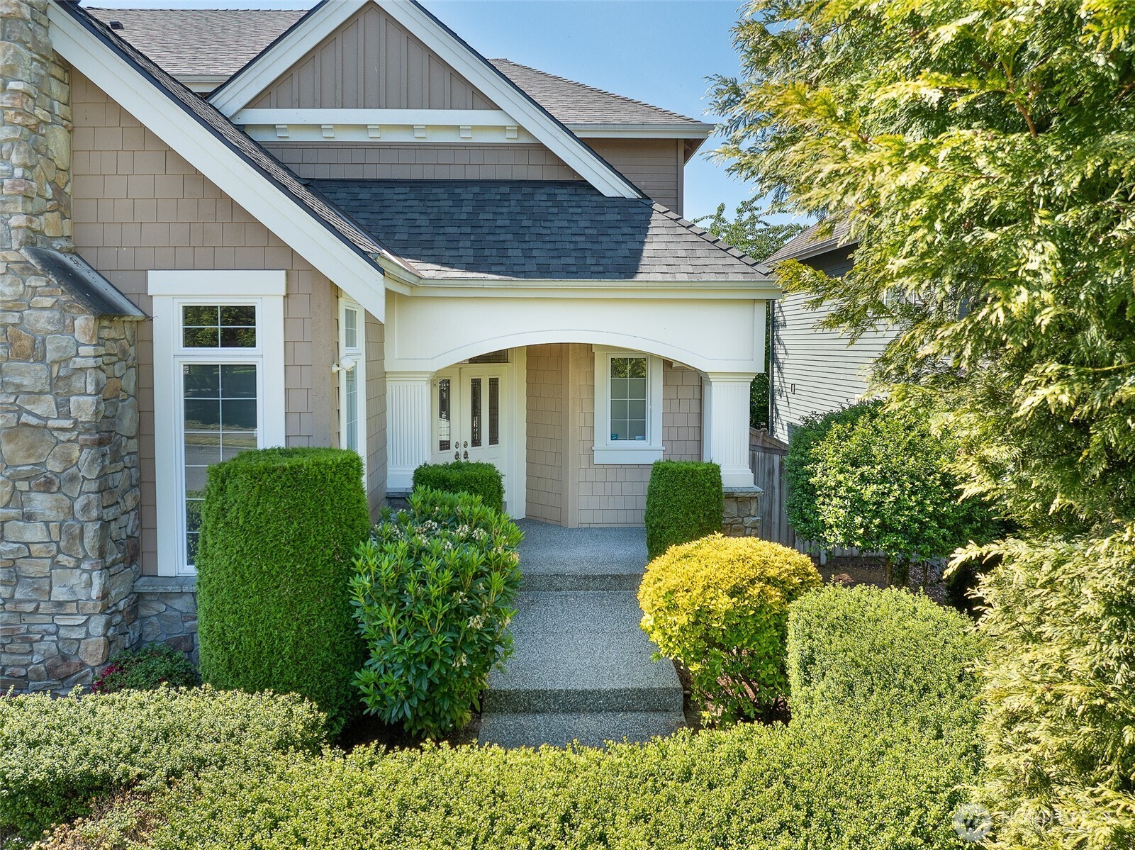 3932 221st Place Southeast Bothell, WA 98021 - Photo 2 of 36 a view of brick house with large windows and plants
